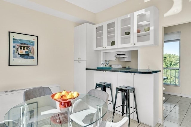 kitchen with white cabinets and light tile patterned flooring