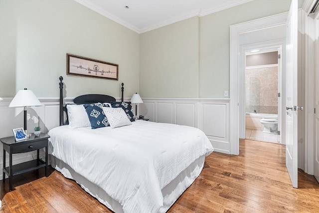 8 Garrison St Unit 104, Boston, MA 02116 - bedroom with wood finished floors, crown molding, a decorative wall, and wainscoting