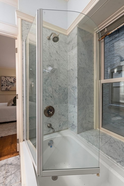 bathroom with separate shower and tub and ornamental molding