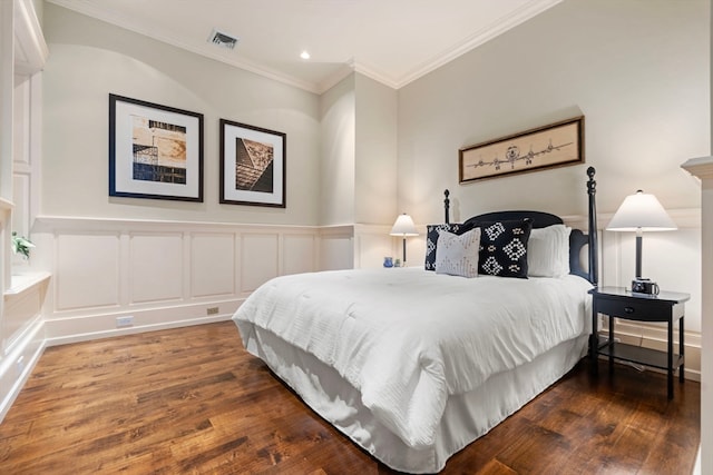 bedroom with ornamental molding and hardwood / wood-style floors