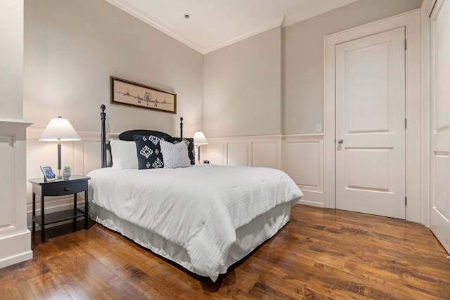 bedroom featuring ornamental molding and dark hardwood / wood-style flooring