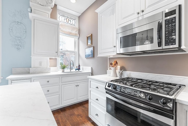 8 Garrison St Unit 104, Boston, MA 02116 - kitchen with stainless steel appliances, a sink, white cabinetry, dark wood-style floors, and recessed lighting