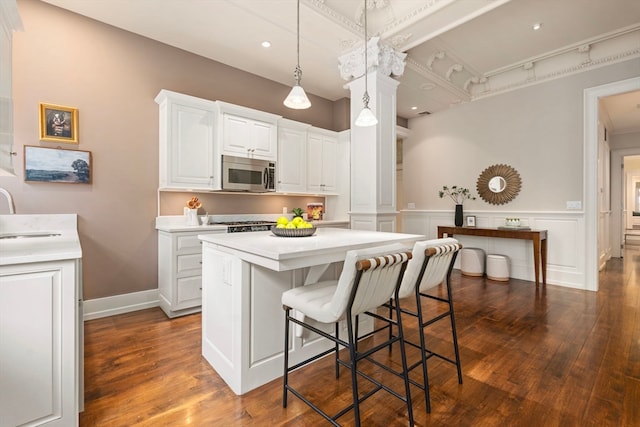 kitchen with white cabinets, pendant lighting, and dark hardwood / wood-style floors