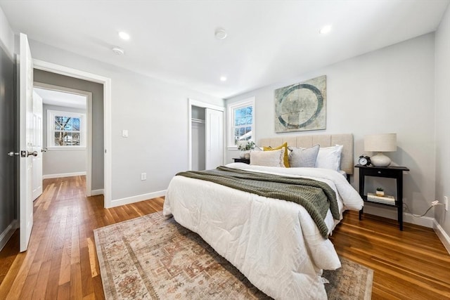 bedroom featuring hardwood / wood-style floors and a closet