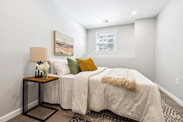 bedroom with dark wood-type flooring