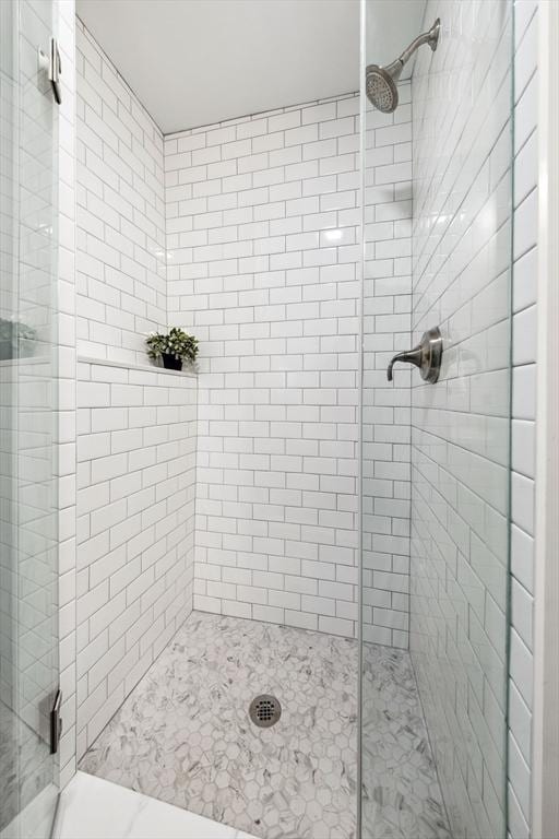 bathroom with a shower with door