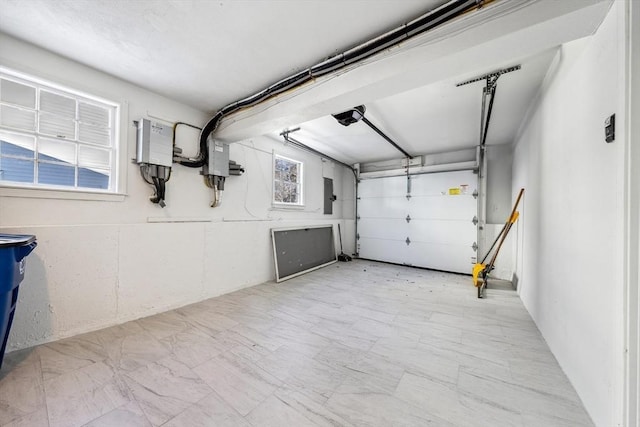 garage with a garage door opener and electric panel