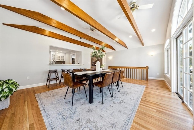 dining room featuring ceiling fan, beam ceiling, and light hardwood / wood-style floors