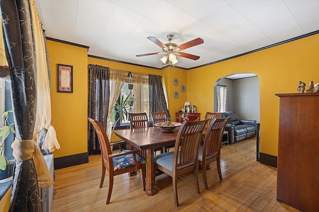 85 Pinehurst Ave, Auburn, MA 01501 - dining area with arched walkways, a ceiling fan, light wood-type flooring, and baseboards