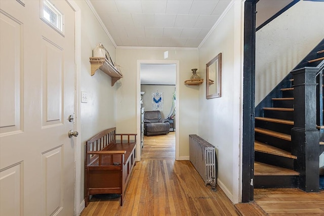 85 Pinehurst Ave, Auburn, MA 01501 - hallway with radiator heating unit, ornamental molding, hardwood / wood-style flooring, stairs, and baseboards