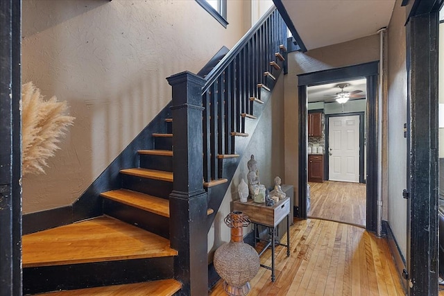 85 Pinehurst Ave, Auburn, MA 01501 - stairs with wood-type flooring, a textured wall, and ceiling fan