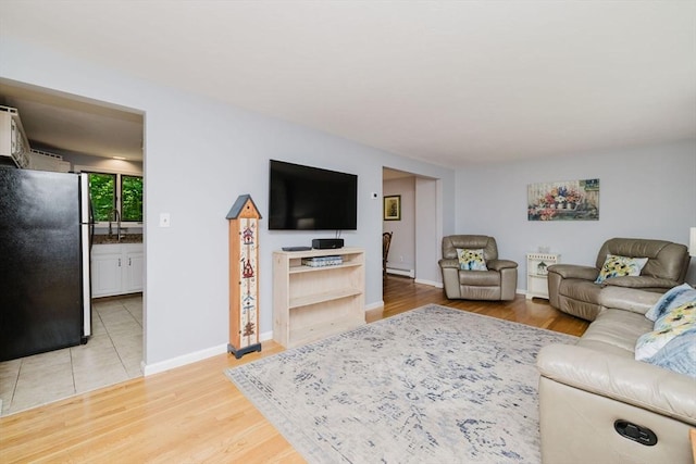 44 Spruce Tree Ln Unit 44, Norton, MA 02766 - living room featuring baseboard heating and light wood-type flooring
