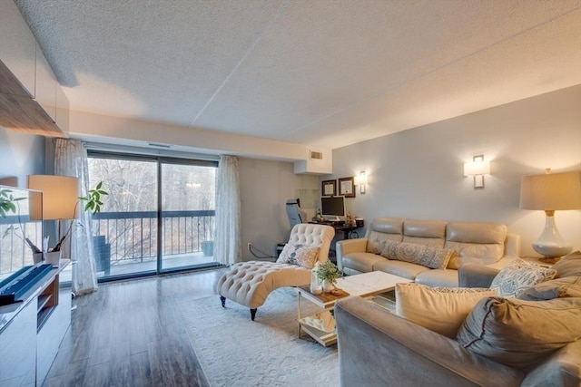 289 Elm St Unit 34B, Medford, MA 02155 - living room featuring a textured ceiling and wood finished floors
