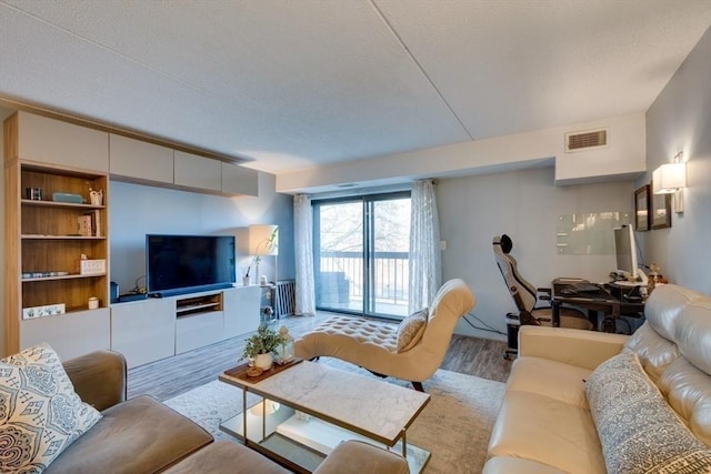 289 Elm St Unit 34B, Medford, MA 02155 - living area featuring wood finished floors and a textured ceiling