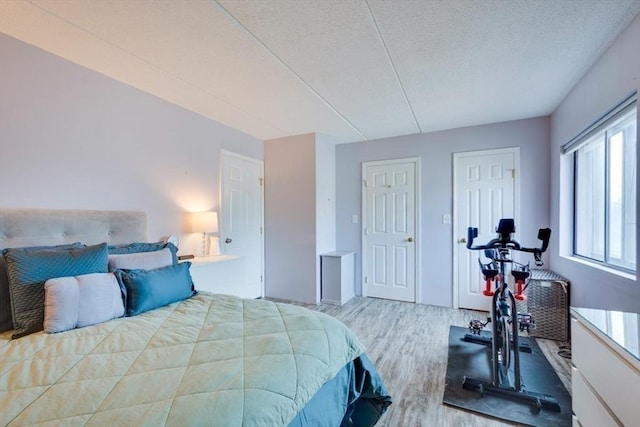 289 Elm St Unit 34B, Medford, MA 02155 - bedroom featuring wood finished floors and a textured ceiling