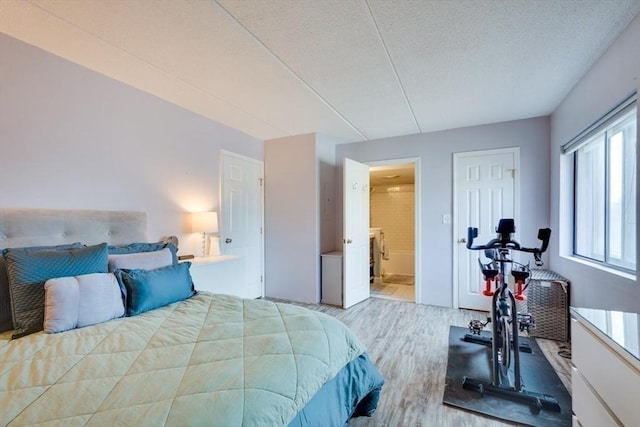 289 Elm St Unit 34B, Medford, MA 02155 - bedroom with wood finished floors, a textured ceiling, and ensuite bathroom