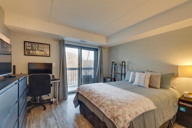 289 Elm St Unit 34B, Medford, MA 02155 - bedroom with access to outside, wood finished floors, an office area, and a tray ceiling