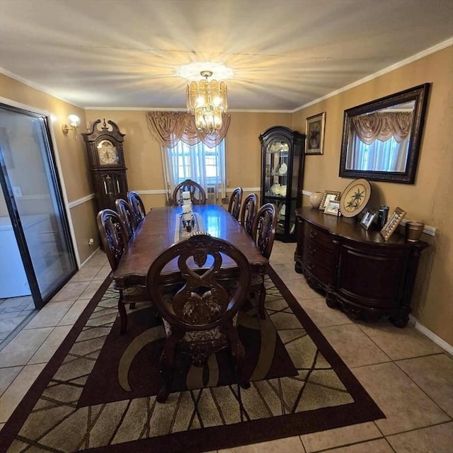 dining area with a chandelier, crown molding, baseboards, and light tile patterned floors