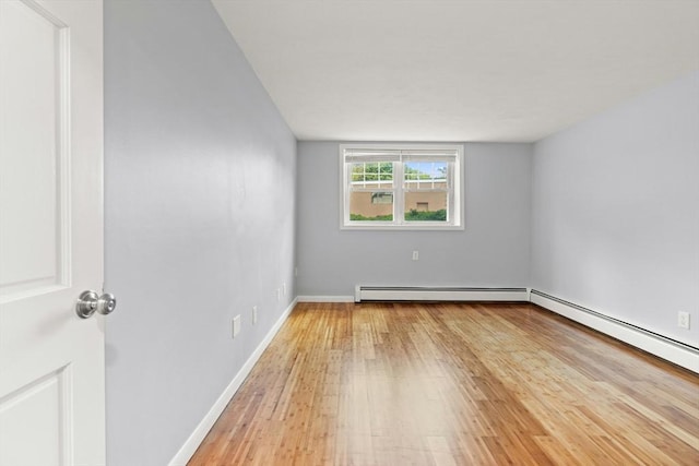 924 Main St Unit 14, Woburn, MA 01801 - unfurnished room featuring light wood finished floors, a baseboard heating unit, and baseboards