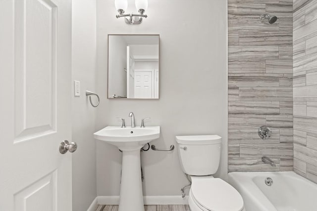 924 Main St Unit 14, Woburn, MA 01801 - bathroom with toilet, baseboards, tub / shower combination, and a sink
