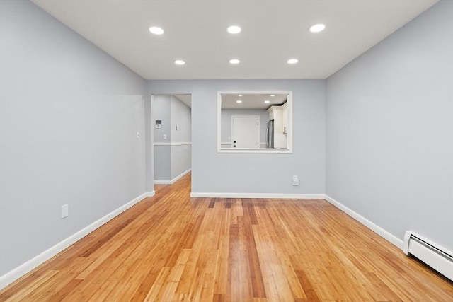 924 Main St Unit 14, Woburn, MA 01801 - spare room featuring a baseboard radiator, recessed lighting, wood finished floors, and baseboards