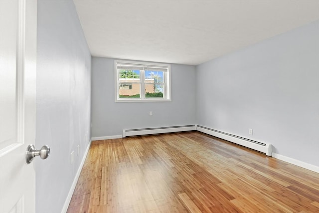 924 Main St Unit 14, Woburn, MA 01801 - empty room with baseboard heating, light wood-style flooring, and baseboards