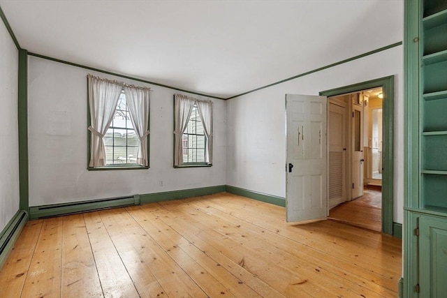 empty room featuring a baseboard radiator, ornamental molding, and light hardwood / wood-style flooring