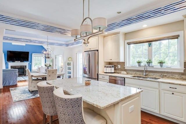 kitchen with pendant lighting, a healthy amount of sunlight, and appliances with stainless steel finishes