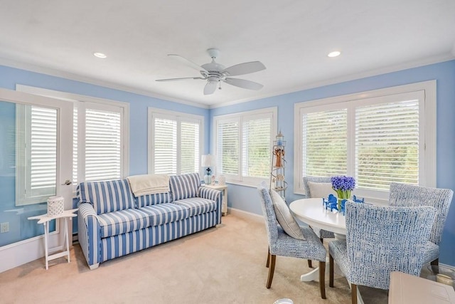 dining space featuring light colored carpet, crown molding, and a wealth of natural light