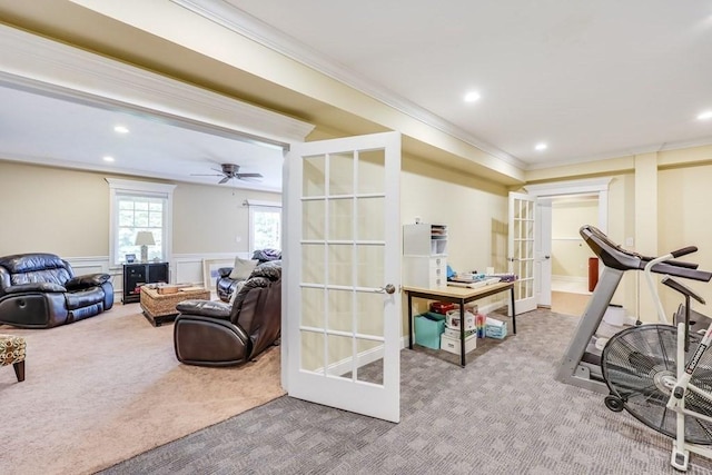 workout room with ceiling fan, crown molding, light carpet, and french doors