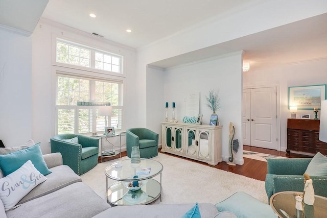 living room with hardwood / wood-style floors and crown molding