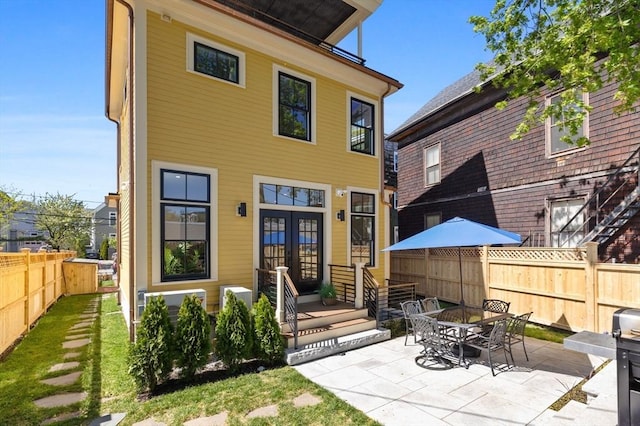 142 Amory St Unit 2, Cambridge, MA 02139 - rear view of house featuring french doors and a patio