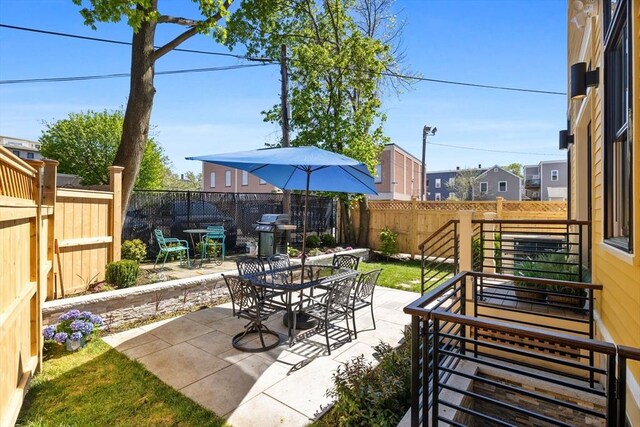 142 Amory St Unit 2, Cambridge, MA 02139 - view of patio / terrace featuring outdoor dining area, a fenced backyard, and area for grilling