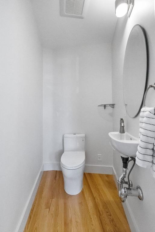 142 Amory St Unit 2, Cambridge, MA 02139 - bathroom featuring wood finished floors and toilet