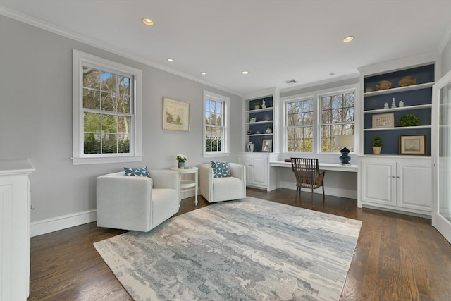 living area with recessed lighting, dark wood-type flooring, built in desk, and crown molding