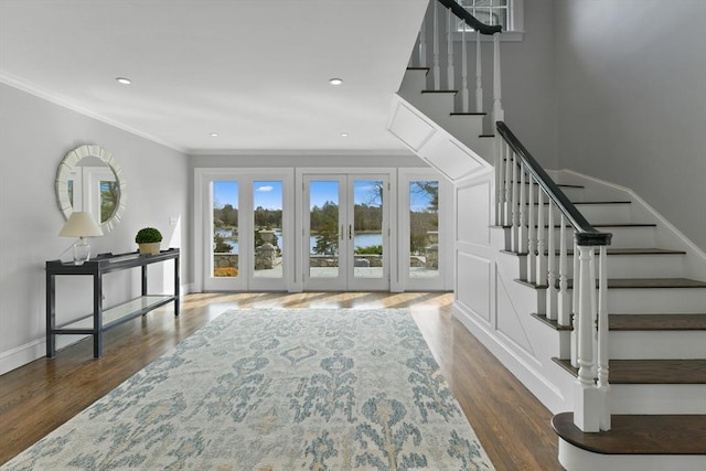 entrance foyer with crown molding, baseboards, stairway, recessed lighting, and wood finished floors