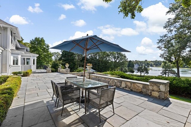 view of patio / terrace featuring outdoor dining area and a water view