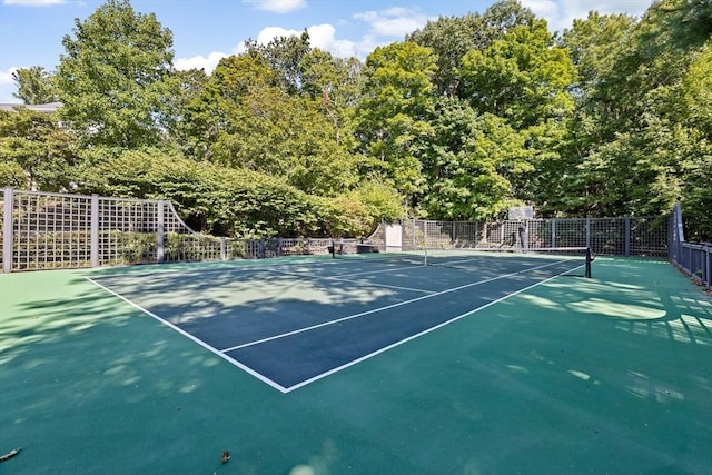 view of sport court featuring fence