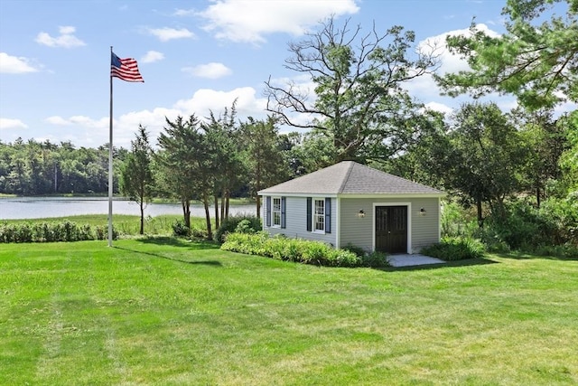 view of yard featuring an outbuilding and a water view