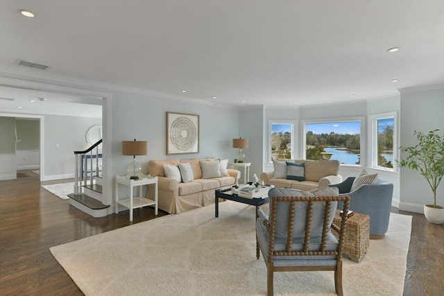 living area featuring visible vents, crown molding, stairway, recessed lighting, and wood finished floors