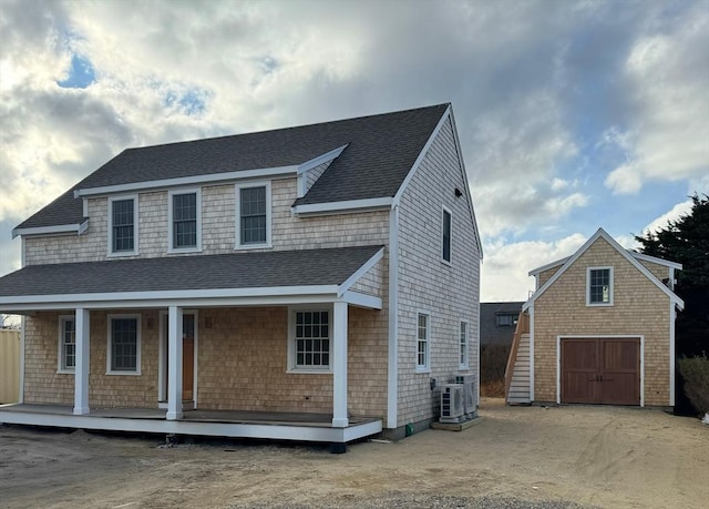 8 Sconset Ave, Nantucket, MA 02564 - view of front of home with a garage, a porch, a shingled roof, dirt driveway, and ac unit