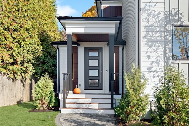 doorway to property with a yard