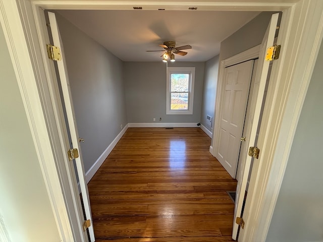 unfurnished bedroom featuring dark hardwood / wood-style floors and ceiling fan