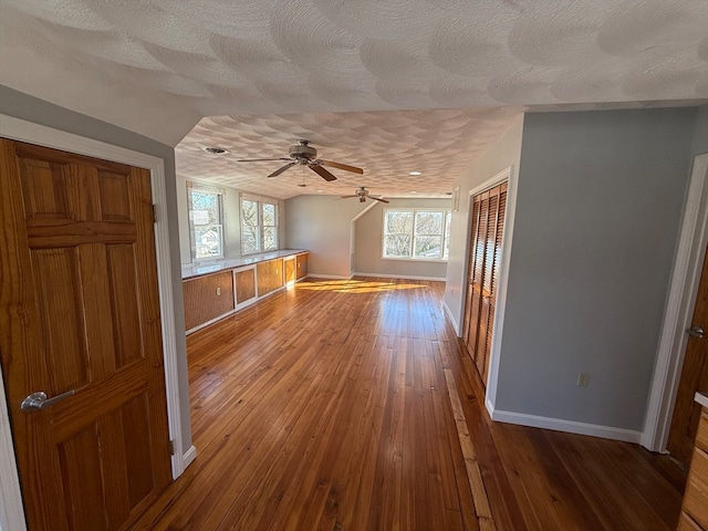 bonus room with ceiling fan, wood-type flooring, a textured ceiling, and vaulted ceiling