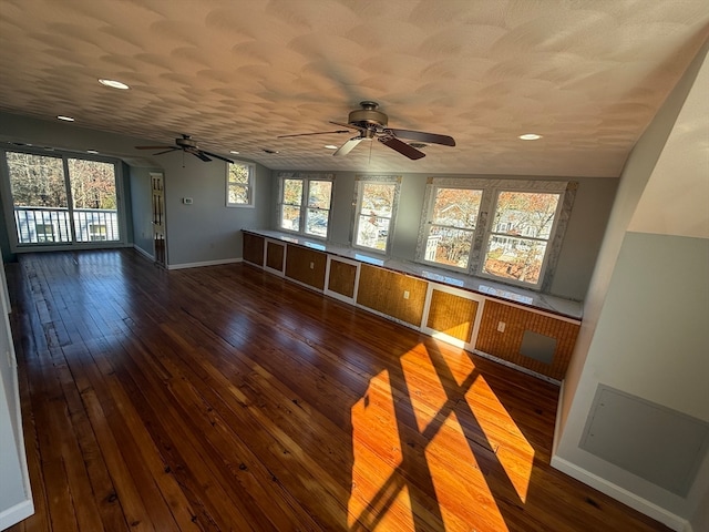 interior space featuring a textured ceiling, ceiling fan, and dark hardwood / wood-style floors