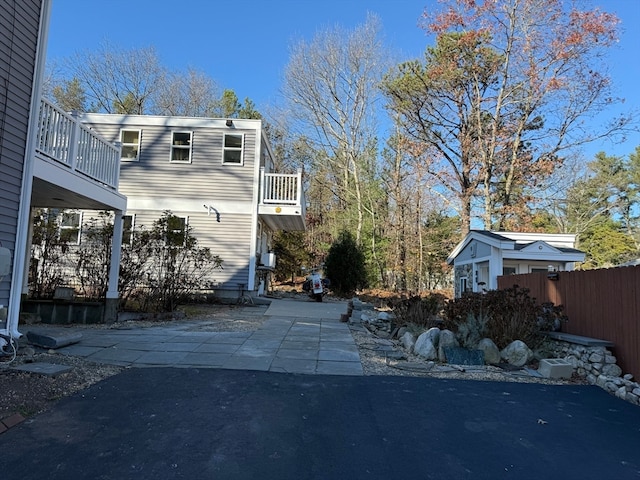 view of property exterior featuring a patio area and a balcony