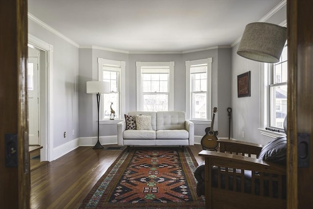 living room with baseboards, ornamental molding, and wood finished floors