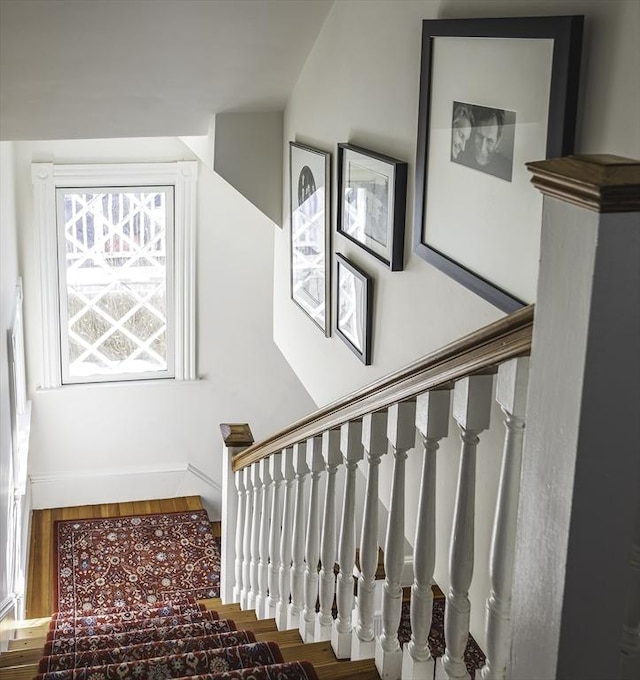 stairs featuring baseboards and wood finished floors