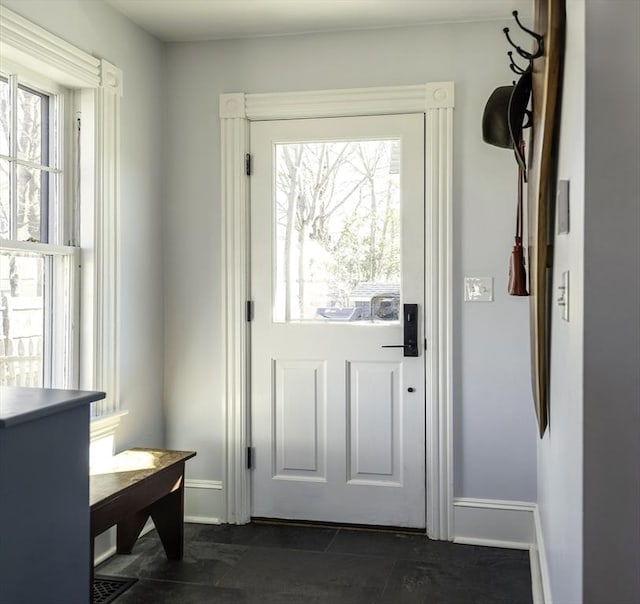 doorway to outside with baseboards