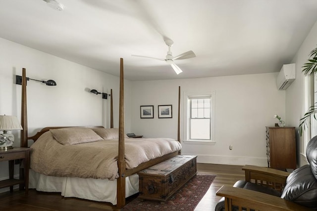 bedroom featuring baseboards, a wall unit AC, a ceiling fan, and dark wood-type flooring